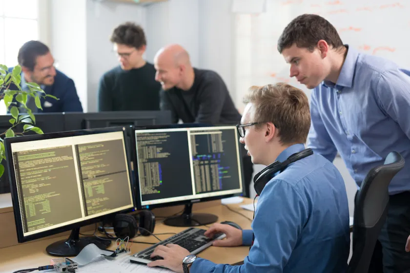 Startup business, software developer working on desktop computer.