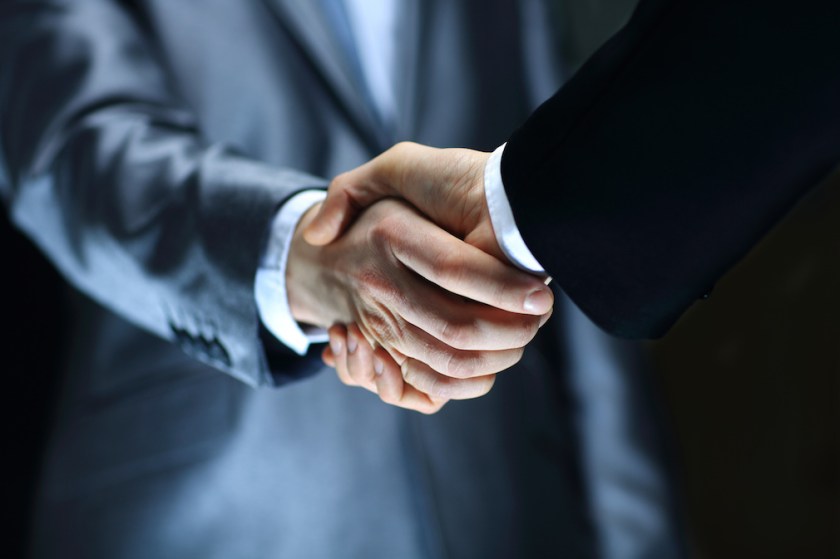 Handshake - Hand holding on black background