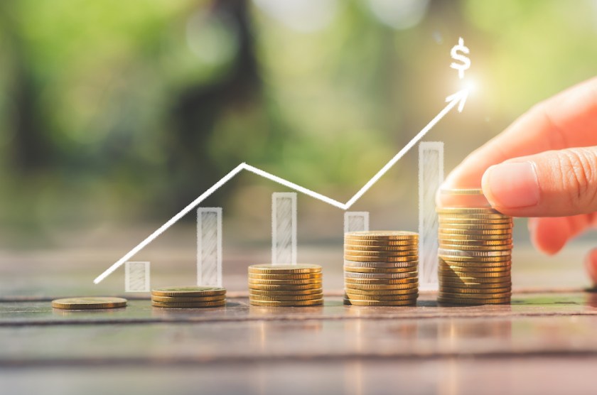loan investment residential building house, real estate, property, mortgage concept. hand put coin stacking on wood table in green park background. startup graph growth up wealth.ESG.financial saving.