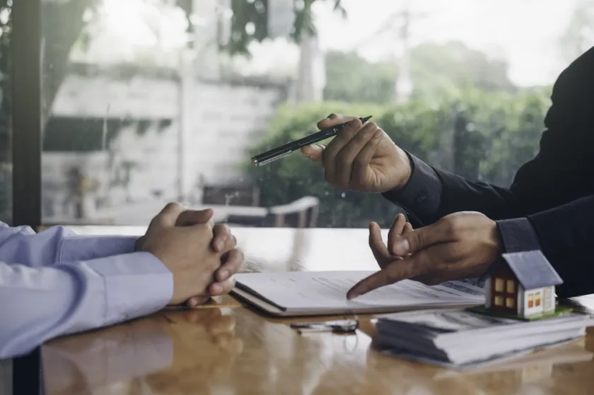 real estate agent holding house key to his client after signing contract,concept for real estate, moving home or renting property