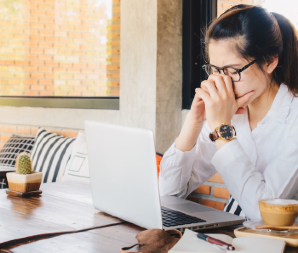 Asian businesswoman worry about her working on her laptop in office.