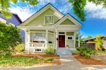 Small cute craftsman American house wth green and white.