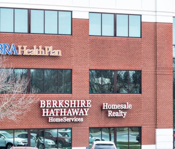 Harrisburg, USA - April 6, 2018: Berkshire Hathaway Home Services Homesale Realty and Vibra Health Plan store signs on building in Pennsylvania