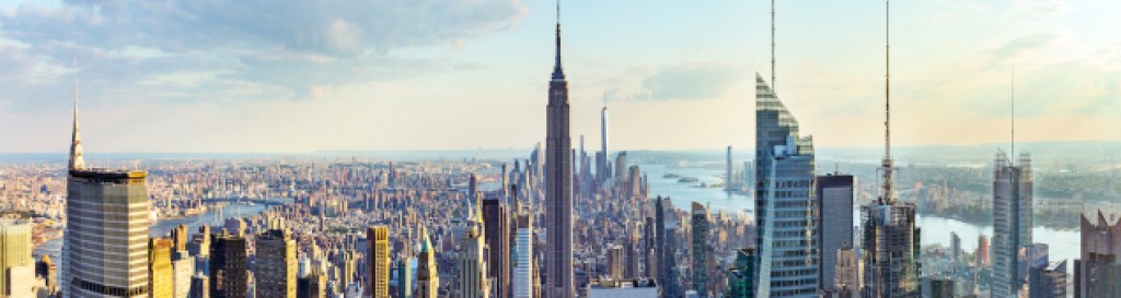 New York City skyline from roof top with urban skyscrapers before sunset.