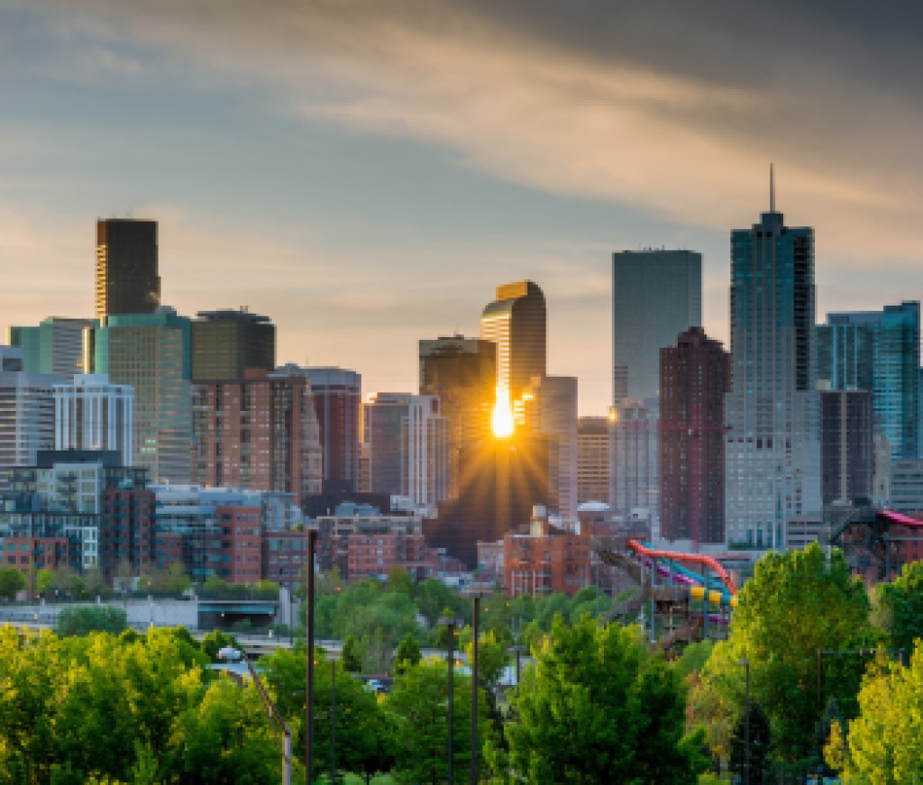 Sunrise peeks through the skyline of Denver