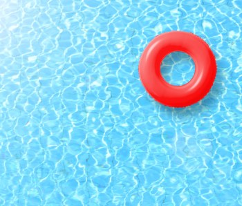 red swimming pool ring float in blue water and sun bright. concept color summer.