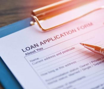 Loan application form with pen on paper / financial loan negotiation for lender and borrower