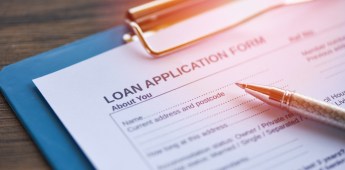 Loan application form with pen on paper / financial loan negotiation for lender and borrower