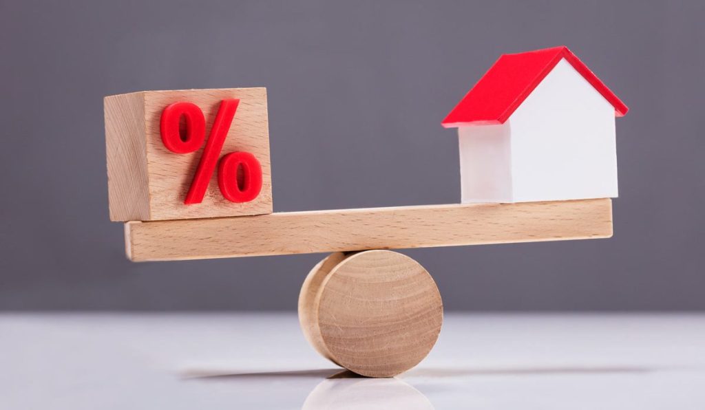 Seesaw Showing Balance Between Percentage Symbol And House Model