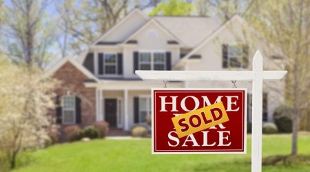 Sold Home For Sale Real Estate Sign and Beautiful New House.