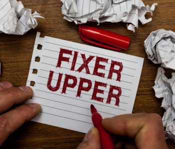 Writing note showing Fixer Upper. Business photo showcasing house in need of repairs used chiefly connection with purchase Man holding marker notebook page crumpled paper several tries mistakes.