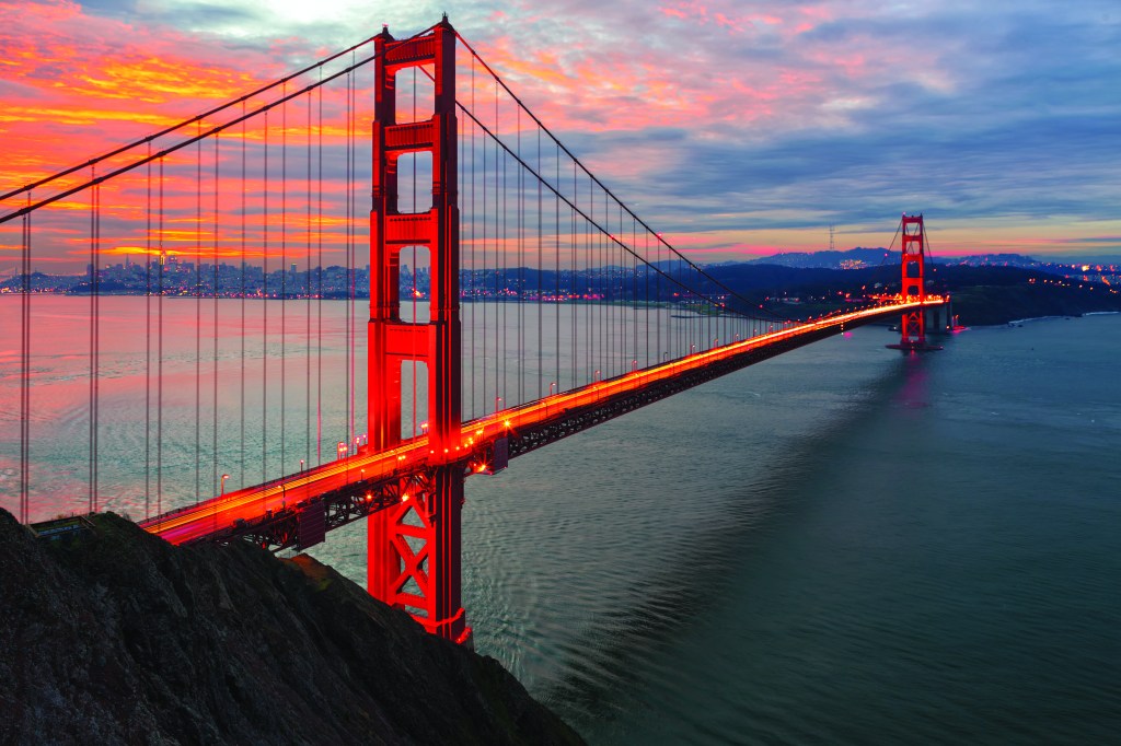 The sun rises over San Francisco and the Golden Gate Bridge