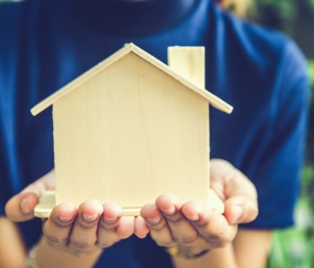 Photo of a miniature house holding in hands