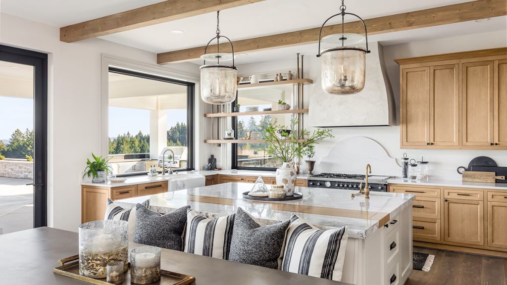 Stylish open kitchen and dining-room with wood ceiling beams and matching cabinets