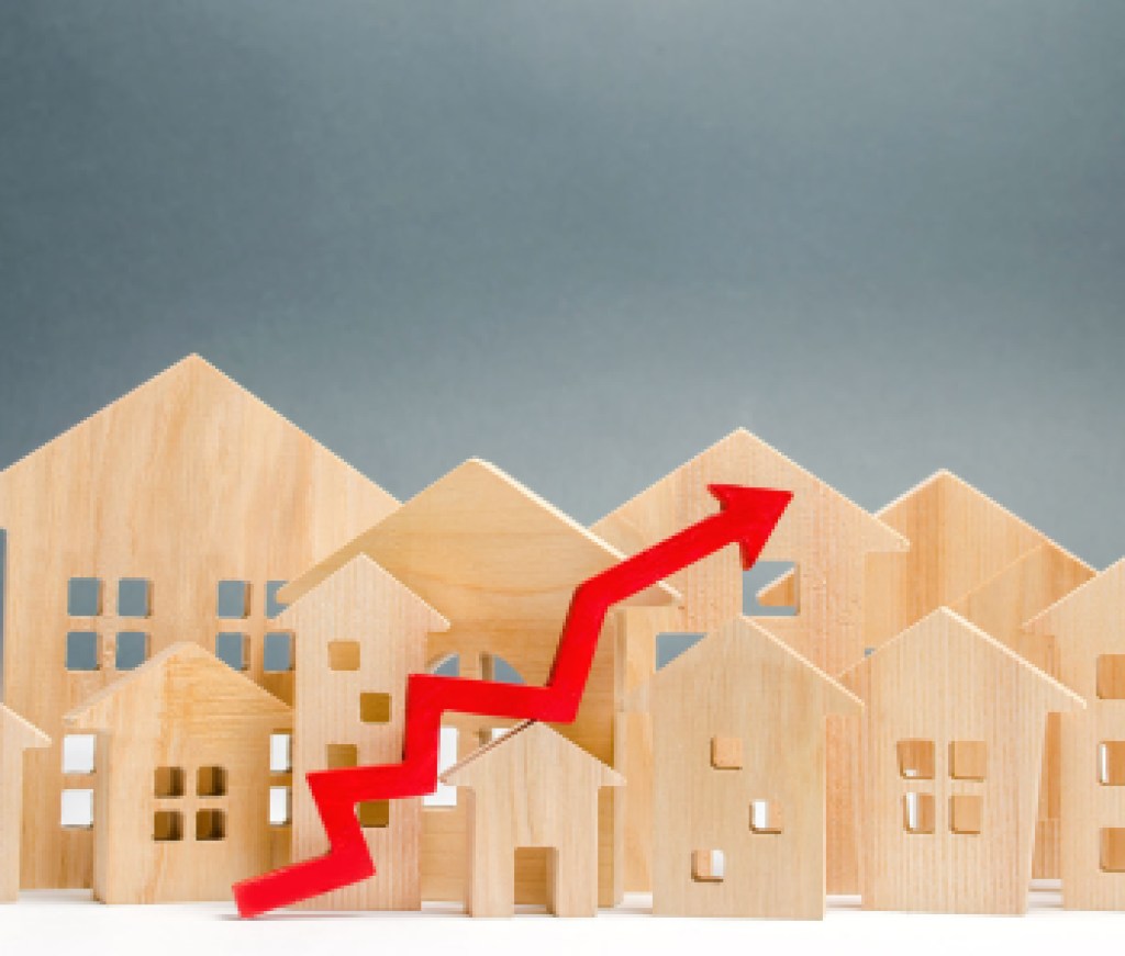 Wooden houses and up arrow. The concept of real estate market growth. The increased in housing prices. Rise price for utilities / rent. Increased demand for housing. Mortgage interest rates are rise