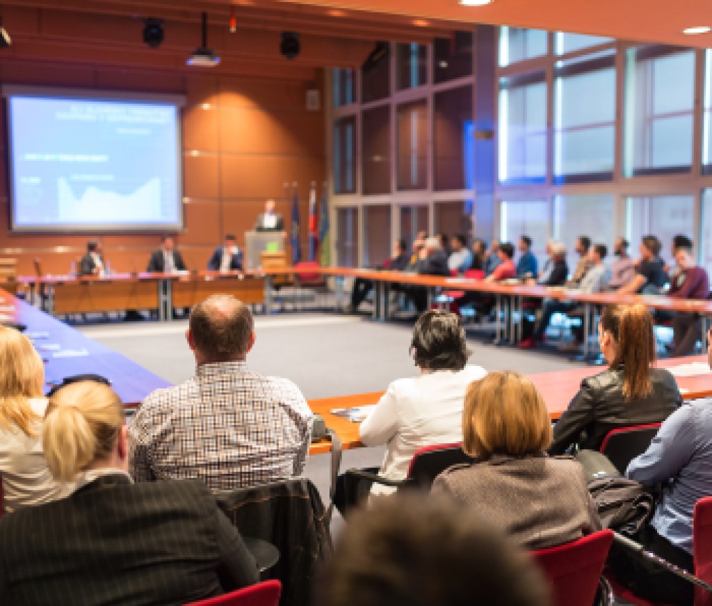 Public speaker giving talk at business event.
