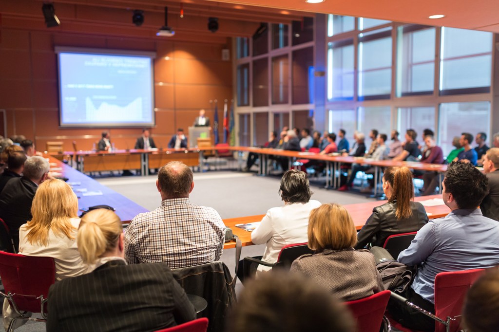 Public speaker giving talk at business event.